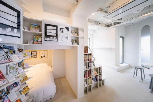a room with a bed and a book shelf at BOOK HOTEL 神保町 in Tokyo