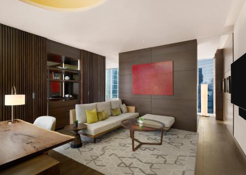 a living room with a couch and a table at Park Hyatt Seoul in Seoul
