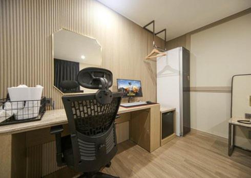 an office with a desk with a phone on it at H Avenue Hwamyeong in Busan