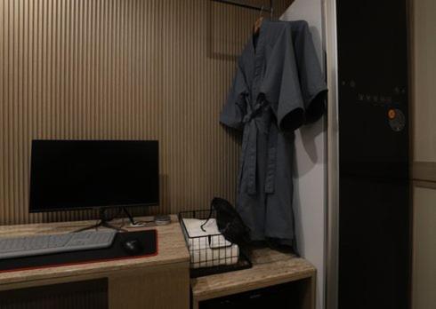 a computer desk with a computer monitor and a keyboard at H Avenue Hwamyeong in Busan