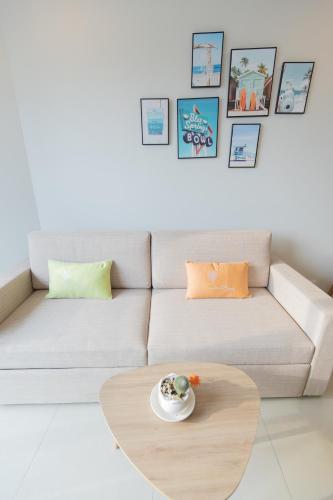 a white couch with a coffee table in a living room at The Song Luxury Condotel Vung Tau - Căn hộ cao cấp Luca's House in Vung Tau