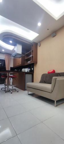 a living room with a couch and a table at Classy! 2BR Apartment - Modern Comfort in West Jakarta CBD in Jakarta