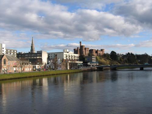 a city with a river and a bridge and buildings at Highland Apartments by Mansley in Inverness