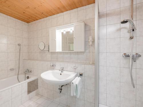 a white bathroom with a sink and a shower at Ferienwohnungen Haid in Oetz