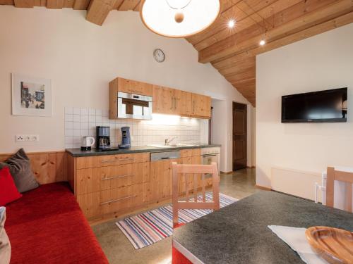 a kitchen with wooden cabinets and a table in a room at Ferienwohnungen Haid in Oetz