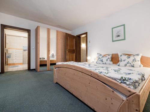a bedroom with a large wooden bed in a room at Ferienwohnungen Haid in Oetz