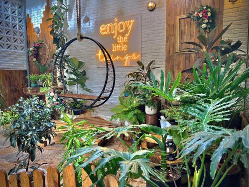 a room filled with lots of plants and a sign at Fati Boutique Hotel & Apartment in Vung Tau