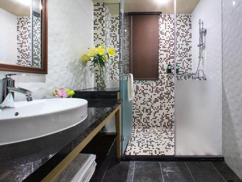 a bathroom with a sink and a shower at Stay Hotel - Taichung Zhongqing in Taichung