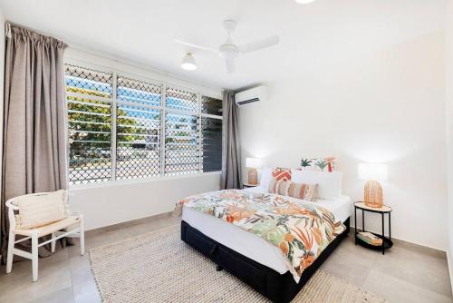 a bedroom with a bed and a large window at 'Botanica Fresca' Chic Nightcliff Convenience in Nightcliff