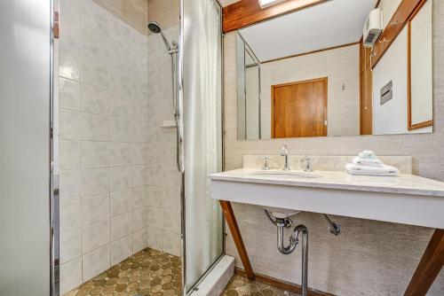ein Badezimmer mit Waschbecken und Dusche in der Unterkunft Grey Kangaroo - 2BR l Lake Front l Pet Friendly l Air-Con l BBQ l WiFi in Jindabyne