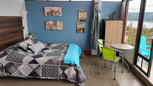 a bedroom with a bed and a table and chairs at Abadia de Tomine in Guatavita