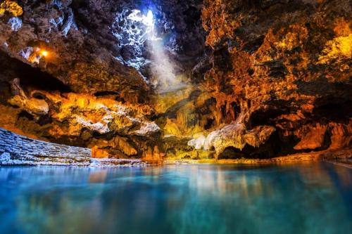 a cave with a blue pool of water in it at Incredible Mountain View Townhouse in DT Canmore w/ A/C & U/A Parking in Canmore