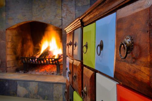 a brick oven with a fire in it at Harry nie z tej bajki & Bałtycka44 Apartments in Olsztyn