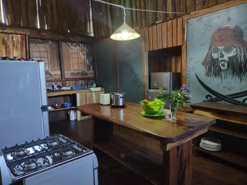 a kitchen with a counter top with a skull on the wall at Barba Negra Adventure House in Sierpe