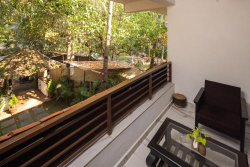 a balcony with a view of a garden at Forget Me Not Resort in Agonda
