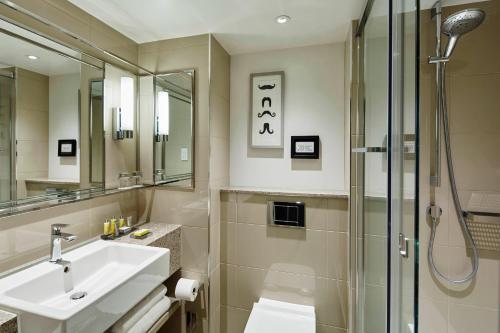 a bathroom with a sink and a shower at London Marriott Hotel Regents Park in London