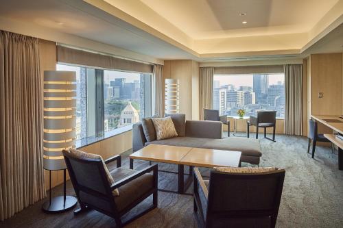 a living room with a couch and a table at The Capitol Hotel Tokyu in Tokyo
