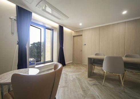 a room with a table and chairs and a window at H Avenue Hwamyeong in Busan