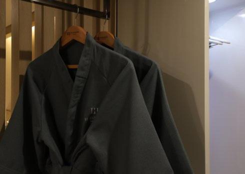 a jacket hanging on a rack in a closet at H Avenue Hwamyeong in Busan