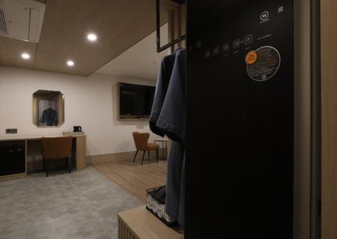 a room with a kitchen and a room with a refrigerator at H Avenue Hwamyeong in Busan