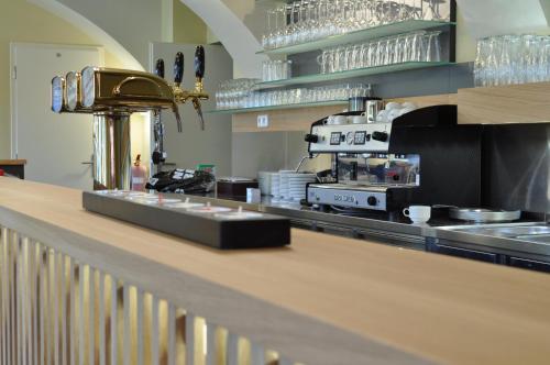 a kitchen with a counter with dishes on it at Hostel Lípa - Továrna in Krásná Lípa