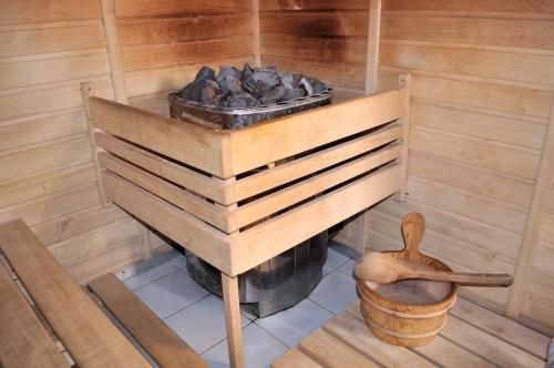 a wooden stove in a room with a pot of coal at Hostel Lípa - Továrna in Krásná Lípa