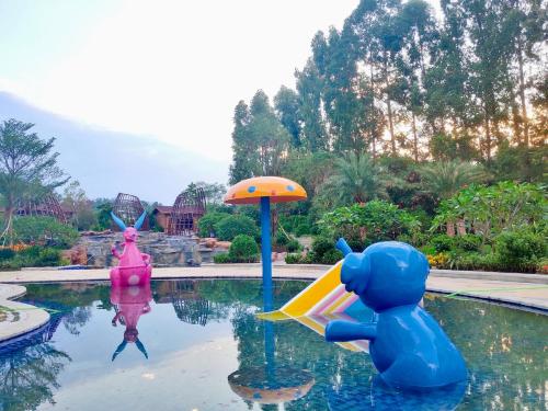 a pool with a toy teddy bear and an umbrella at Wyndham Grand Zhaoqing Downtown in Zhaoqing