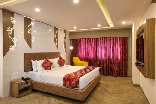 a hotel room with a bed and a window at Mango Hill Central Chennai in Chennai