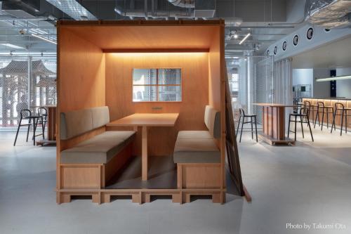 a booth in a room with a table and chairs at KAIKA Tokyo by THE SHARE HOTELS in Tokyo