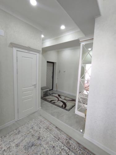 een lege kamer met een witte deur en een muur bij Prestigious apartment in Bishkek in Bisjkek