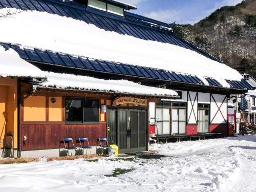 a building with snow on top of it at Hanasaku Onsen Yoshiyaso in Katashina
