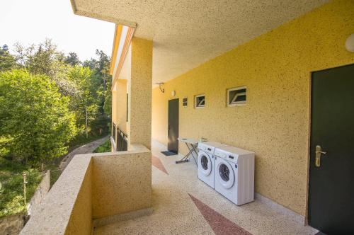 a washing machine sitting on the side of a building at Hotel "Sakvareli Sahli" Любимый дом in Tsikhisdziri