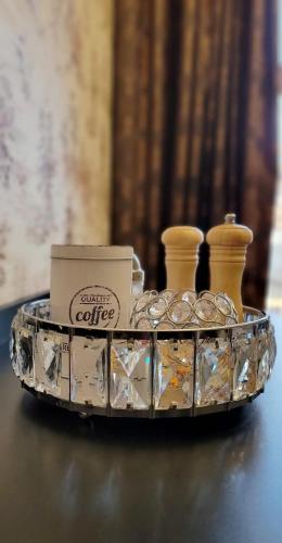 a tray with cups and a box on a table at CezAri ApartHotel in Braşov