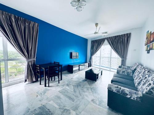 a blue living room with a couch and a table at PD MARINA RESORT 2 in Port Dickson