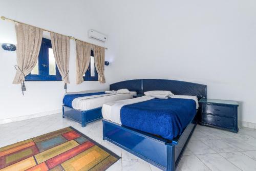 a bedroom with two beds and a rug at New Panorama Resort in Fayoum Center