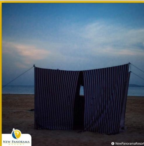 a net on the beach with the ocean in the background at New Panorama Resort in Fayoum Center