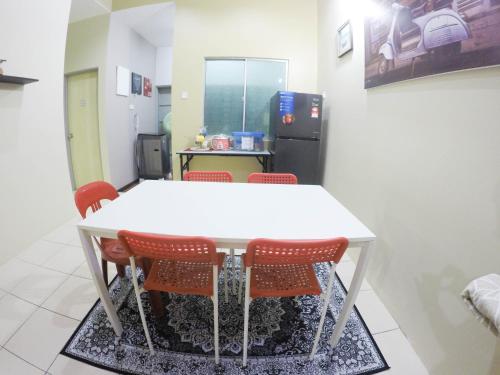 a white table and chairs in a room at D HOMESTAY SERI ISKANDAR in Seri Iskandar