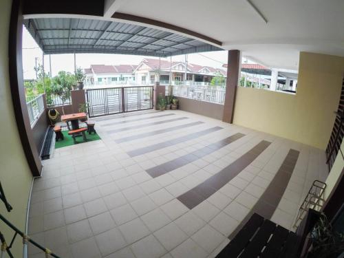 an empty balcony of a house with a view of the patio at D HOMESTAY SERI ISKANDAR in Seri Iskandar