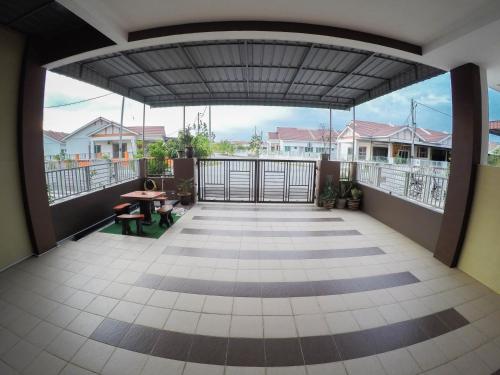 a balcony with a view of a house at D HOMESTAY SERI ISKANDAR in Seri Iskandar