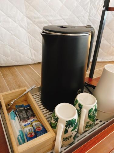 a black trash can sitting on top of a table at Touch Glamping Koh Yao Noi ทัช แกรมปิ้ง เกาะยาวน้อย in Ko Yao Noi