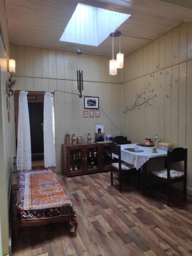 a room with a table and chairs and a table at Darjeeling BnB in Darjeeling