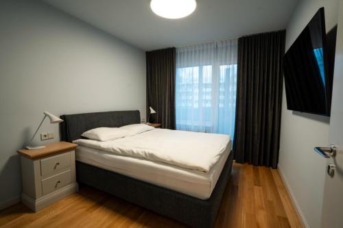 Ένα ή περισσότερα κρεβάτια σε δωμάτιο στο Sunrise Ugales Apartments