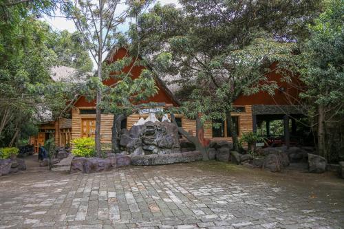 a house with a fountain in front of it at Dovenest Lodge in Naivasha