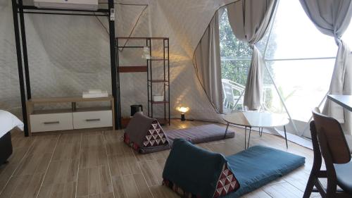 a room with a bed and a ladder in a tent at Touch Glamping Koh Yao Noi ทัช แกรมปิ้ง เกาะยาวน้อย in Ko Yao Noi