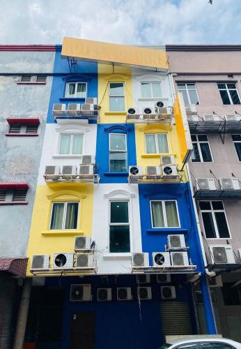 a brightly colored building with windows and balconies at Sun Inns D'mind 3 Seri Kembangan in Seri Kembangan