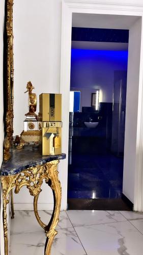 a gold table with boxes on it in a room at Cannatella's Mansion in Palermo