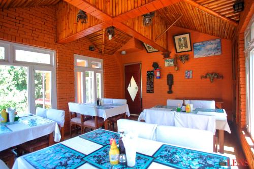 a dining room with white tables and white chairs at Melungtse apartment in Kathmandu