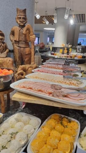 a buffet line with different types of food on trays at Kraljevi Konaci Olja in Zlatibor
