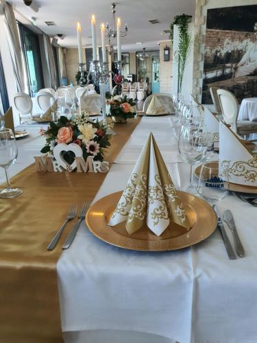 a long table with plates and napkins on it at Regina Maria Spa Design Hotel in Balchik