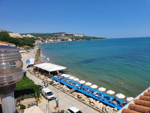 a view of a beach with umbrellas and the ocean at Regina Maria Spa Design Hotel in Balchik